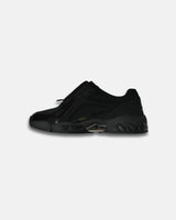 LA SXEPPA Black shoe, side profile with the center zip and bubble sole