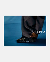 LA SXEPPA Black shoe worn on foot, SXEPPA editorial